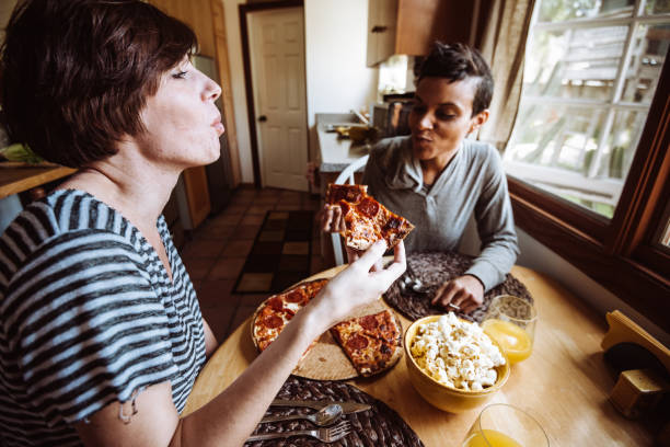 istock lesbian couple eating pizza togetherness 918322370