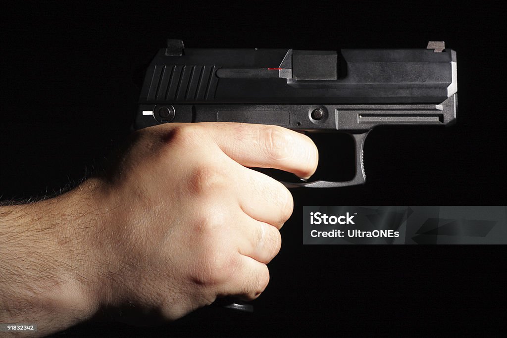 Pistol in man hand.  Aiming Stock Photo