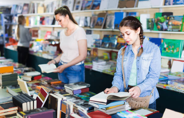 istock Smiling daughter is flipping books 918325170