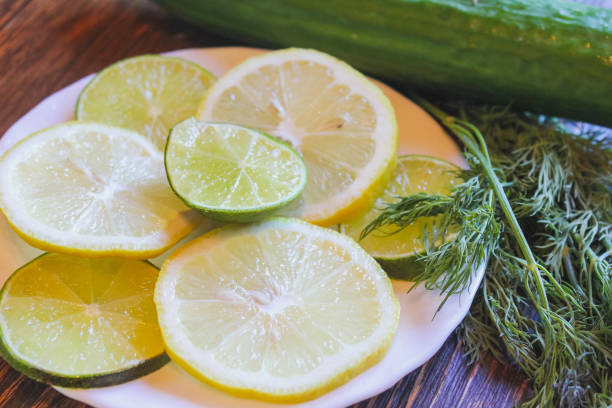 istock Lemon and lime slices close-up. Citrus on plates. Yellow with green. 918325482