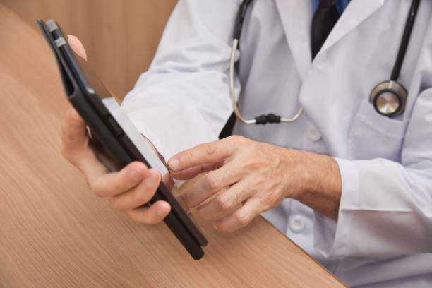 istock Close up Asian male Doctor hands using digital tablet computer. 918325488