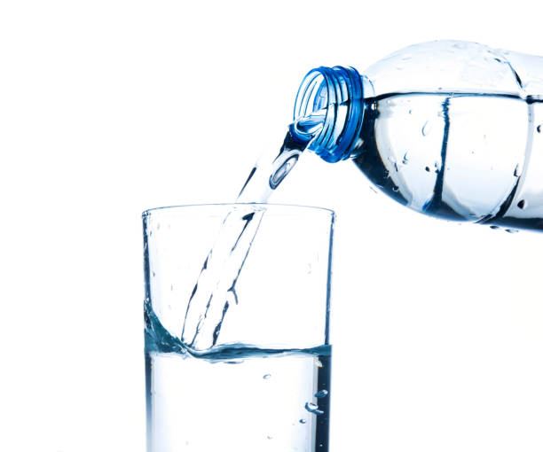 istock Pouring water from bottle into glass 918326318