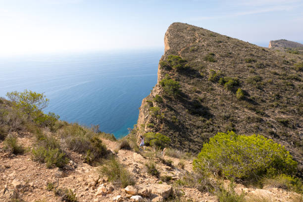 istock Steep cliff with blue sea behind 918335474