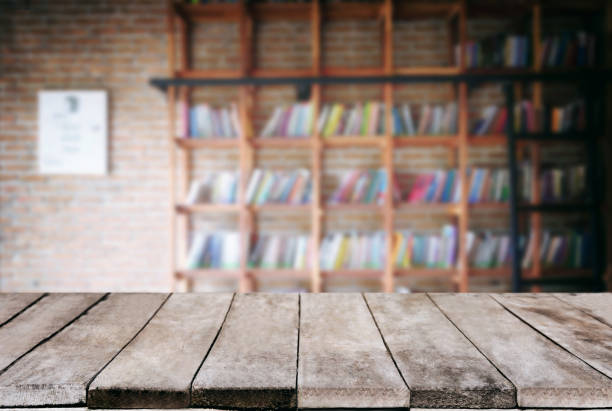 istock Selected focus empty old wooden table and Library or Bookstore blur background with bokeh image. for your photomontage or product display 918335572