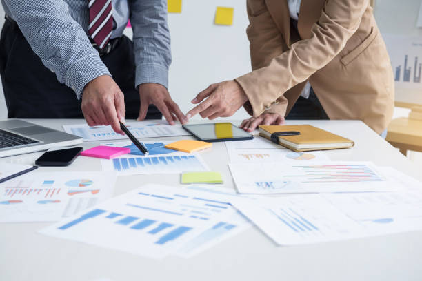 istock Business team two colleagues discussing new plan financial graph data on office table with laptop and digital tablet 918335612