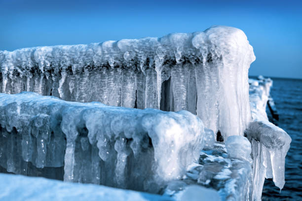 Frozen jetty on the sea. Ice, winter time