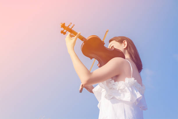 Beautiful women enjoy playing violin