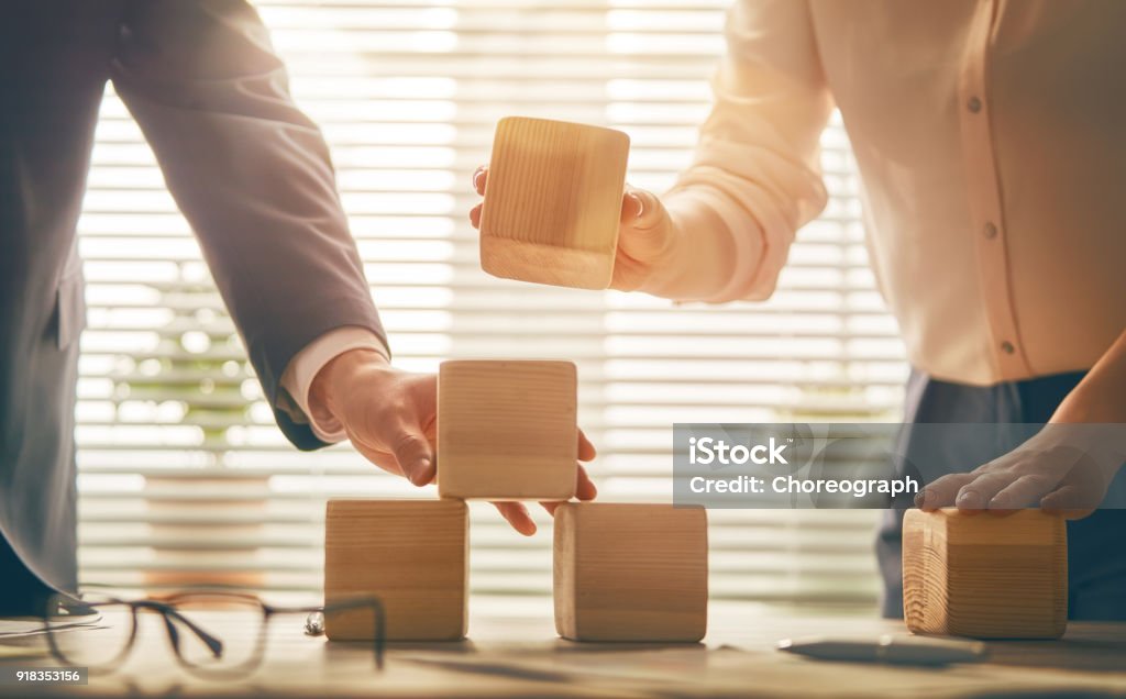 business persons plan a project two business persons plan a project. team work in office Toy Block Stock Photo