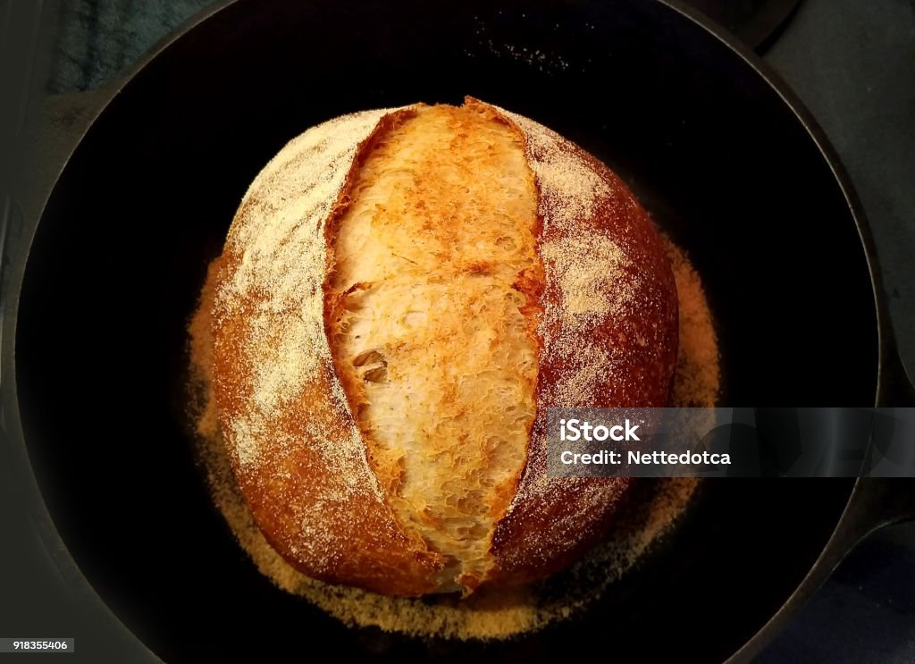 Homemade sourdough bread in black pan Homemade sourdough bread in black cast iron pan Baked Stock Photo