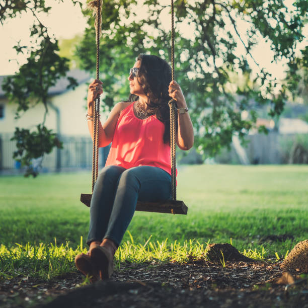 istock Woman swinging on the country side 918361672