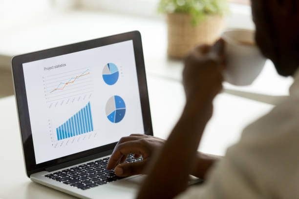 istock African american businessman working with project statistics on laptop screen 918364522