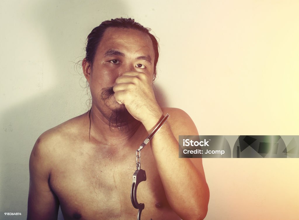 portrait of a man prisoner with handcuff Adult Stock Photo