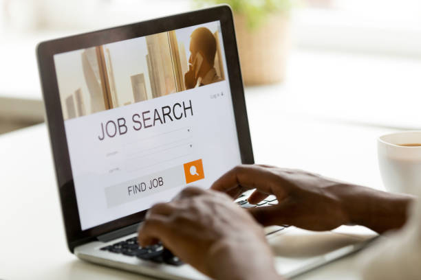 African-american man browsing work online using job search computer app African man browsing work opportunities online using job search computer app, black jobless seeker looking for new vacancies on website page at laptop screen, recruitment concept, rear close up view job search stock pictures, royalty-free photos & images