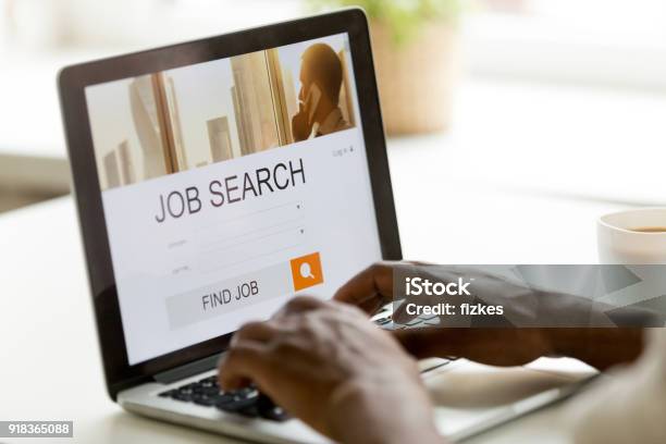 Africanamerican Man Browsing Work Online Using Job Search Computer App Stock Photo - Download Image Now