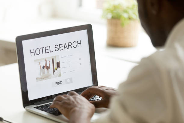 istock African-american man browsing hotel online using search app on laptop 918365096