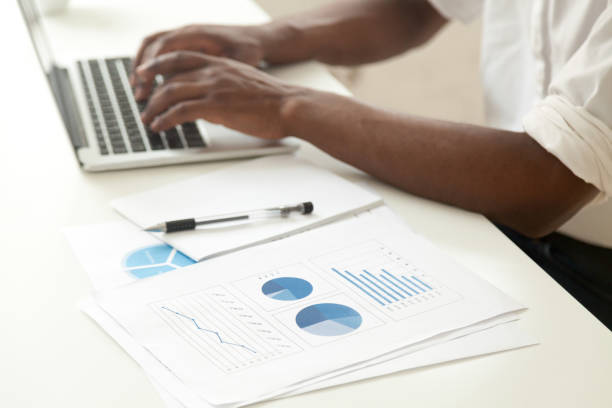 istock Data analysis and business statistics concept, african-american businessman analyzing stats 918365132