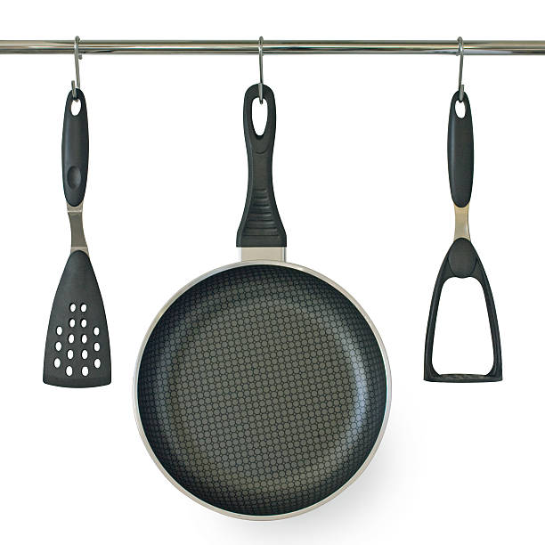 istock Fry pan and kitchen utensils hanging on a rail 91836716