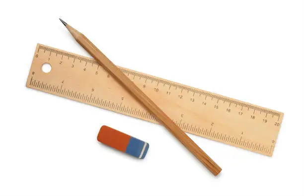 Ruler, pencil and eraser isolated on white
