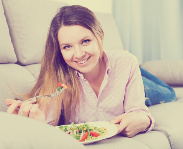 istock Woman tasting fresh green salad 918374900