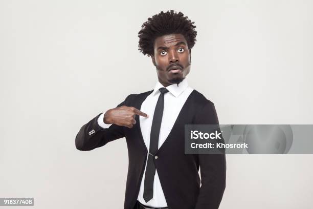 Amazement Aloof Afro Man Looking At Camera Studio Shot Gray Background Stock Photo - Download Image Now