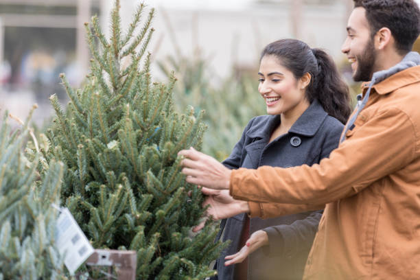 istock Couple picking out Christmas tree 918377506