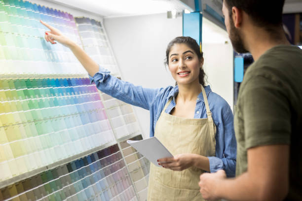istock Paint store sales person assists customer 918377538