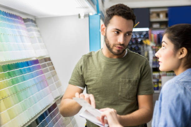 istock Couple have conflict choosing paint colors 918377542