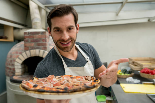 istock Waiter serving pizza at an Italian restaurant 918377646
