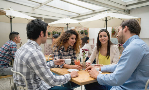 istock Happy group of friends drinking coffee at a cafe 918377668