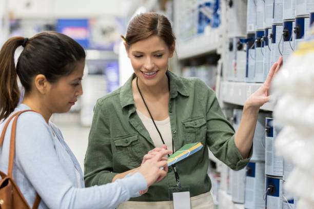 istock Female hardware store customer talks with sales associate 918377878