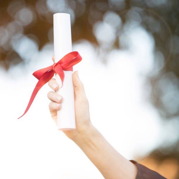 istock Unrecognizable woman holding college diploma 918377982