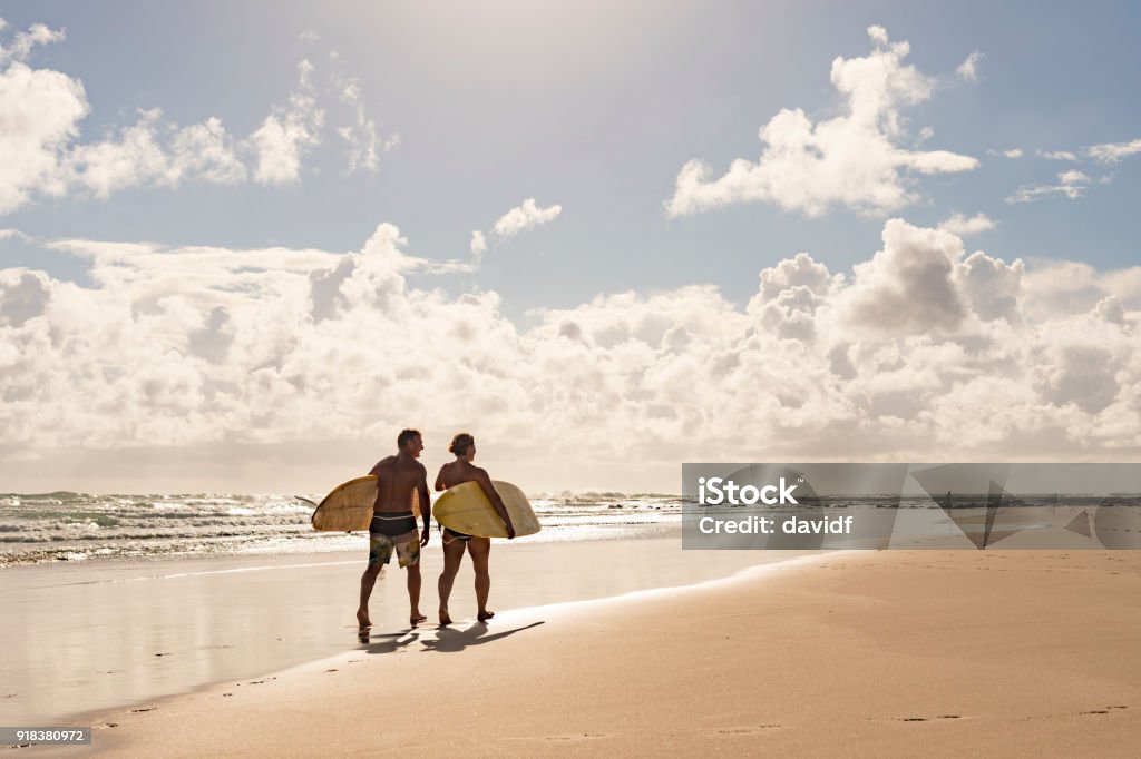 Middle Aged Couple With Malibu Longboard Surfboards Two Middle Aged People With Malibu Longboard Surfboards Beach Stock Photo