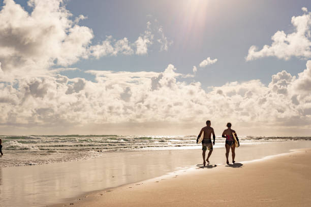 istock Middle Aged Couple With Malibu Longboard Surfboards 918380974