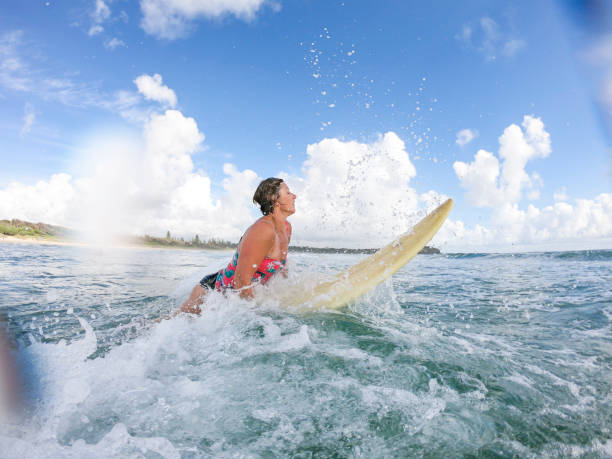 istock Middle Aged Woman Surfing at the Beach 918381346