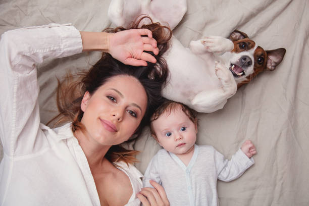 istock young mother and a little child with dog 918381786