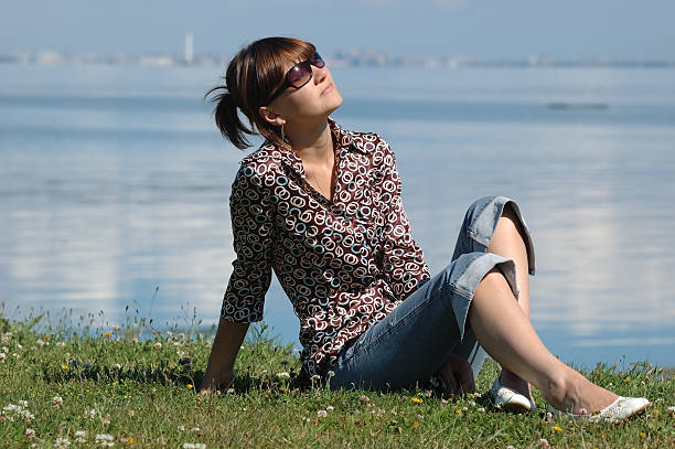 Sunbathing girl on the grass stock photo