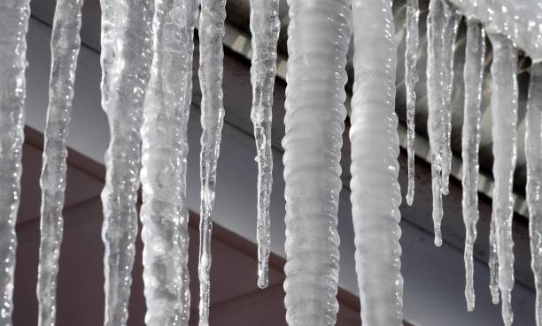 istock Close up of icicles hanging from the gutter. 918384206