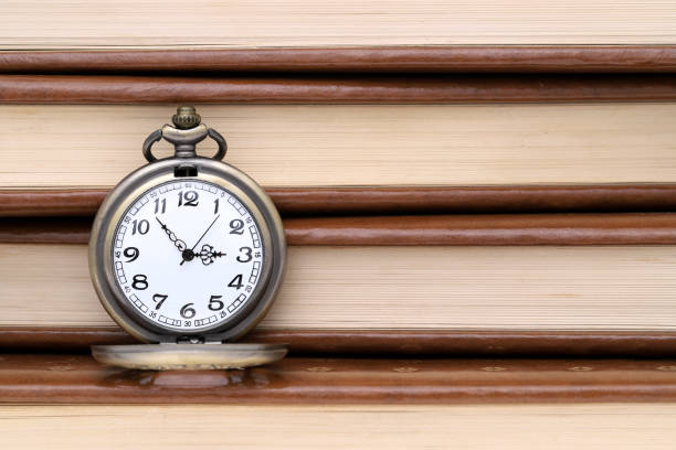 istock Vintage pocket watch and old book 918384636