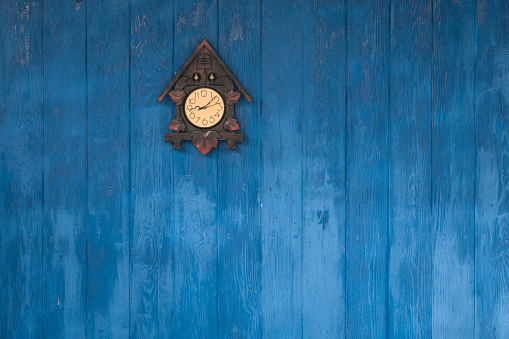 blue wooden wall with wall clock