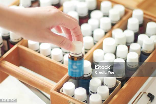 Woman Choosing Essential Oil Stock Photo - Download Image Now - Essential Oil, Aromatherapy, Aromatherapy Oil