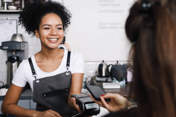 istock Customer paying with her mobile phone at a small cafe 918392200