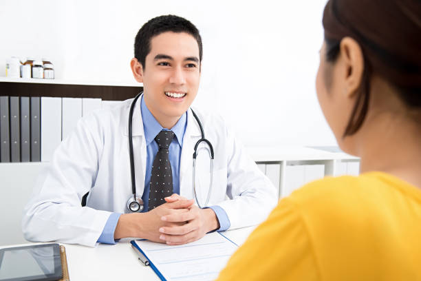 istock Handsome Asian doctor sharing information with patient 918395536