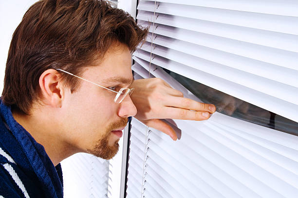 istock Young man in bathrobe looking out of the window 91839768