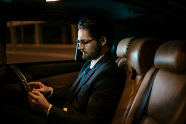 istock Businessman in car at back seat 918402536