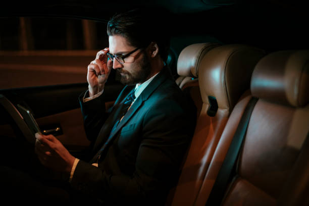istock Businessman in car at back seat 918403716