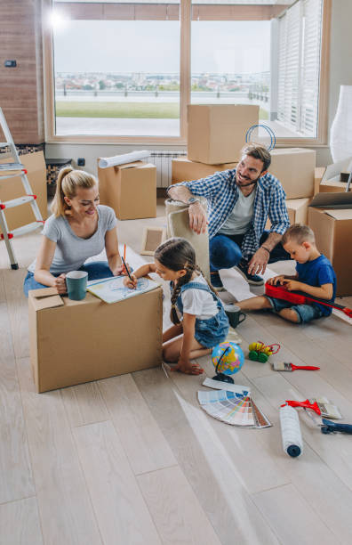 istock Young family having fun while moving into new apartment. 918403956