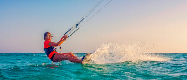 istock Female kiteboarder on turquoise water 918406136