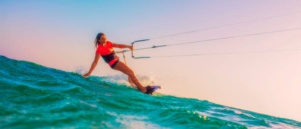istock Female kiteboarder tracing her hand through the water 918406386