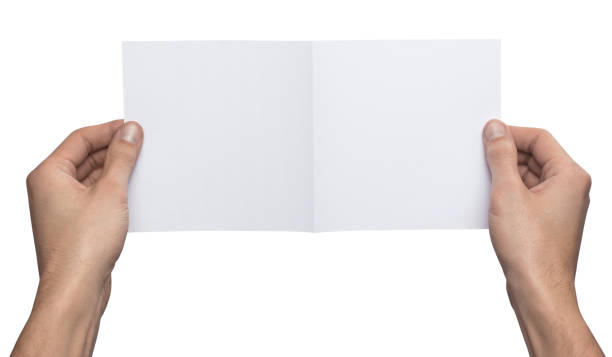 istock Mockup square empty blank bent in half white postcard holds the man in his hand. Isolated on a white background 918406758