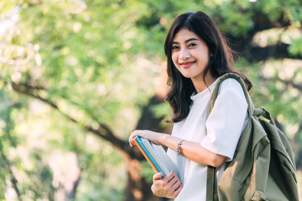 istock Woman students holding notebooks outdoors.Education concept 918407028